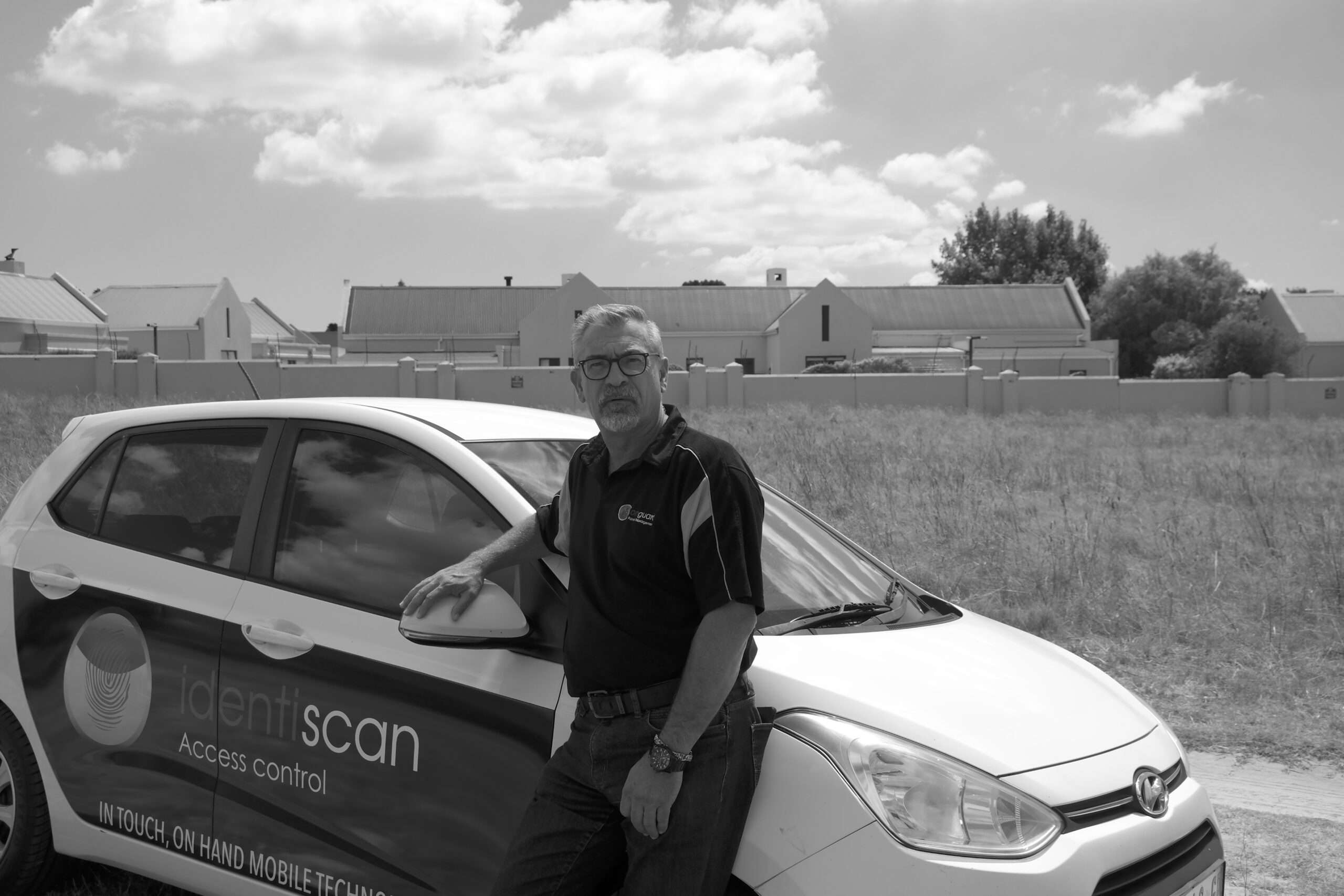 Identiscan team member beside a branded access control vehicle